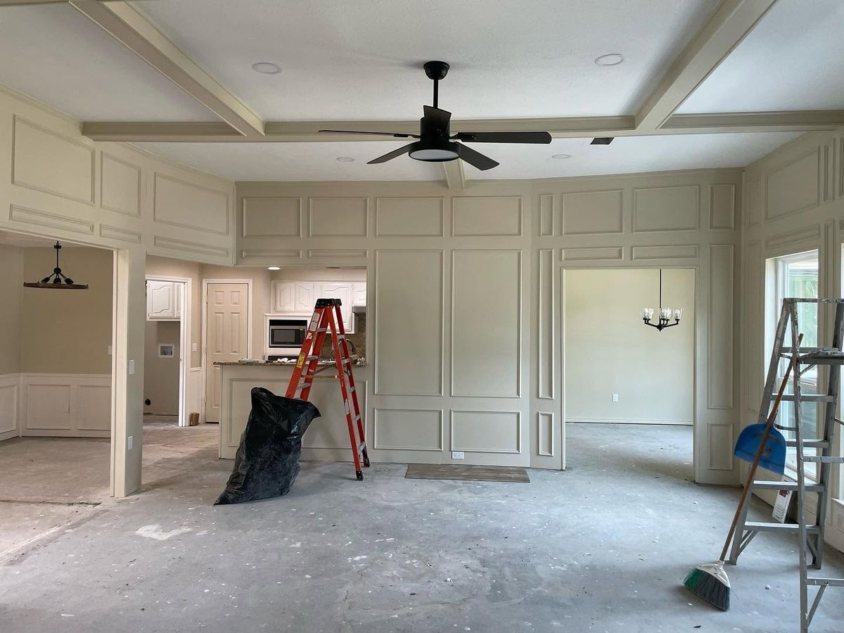 Painted wall paneling with a view into the kitchen and dining room